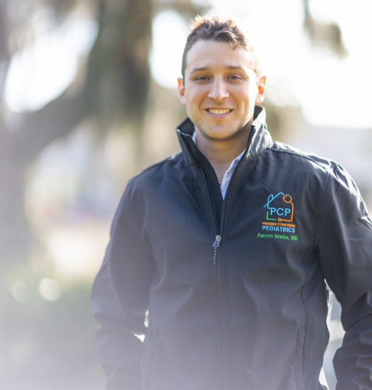 Orlando concierge pediatrician Doctor Aaron Weiss smiling outdoors