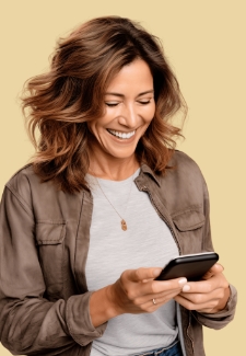 Woman smiling while looking at her phone