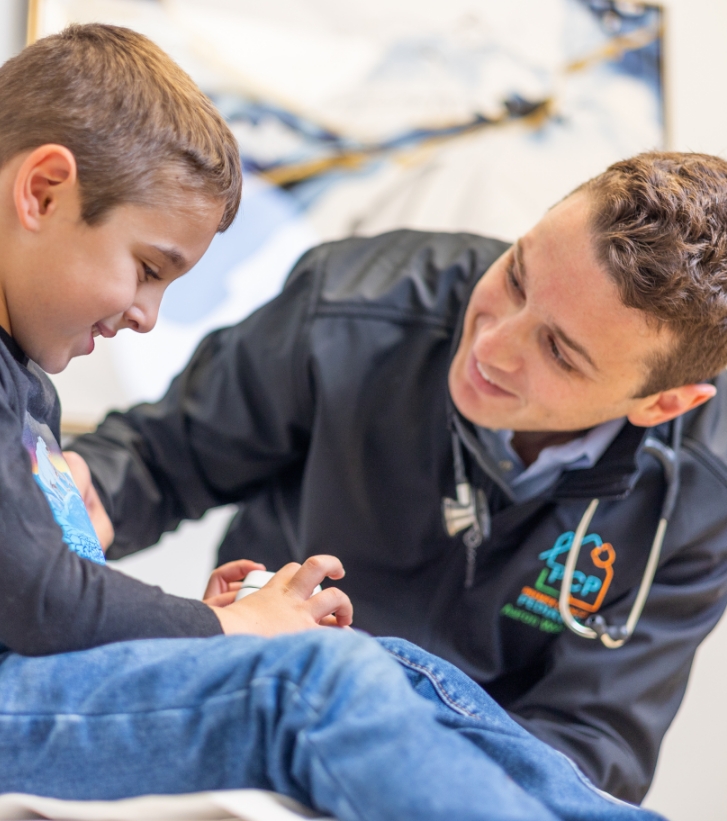 Doctor Weiss talking to a young boy patient