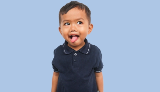 Toddler boy sticking his tongue out