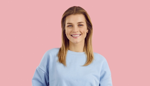 Smiling teenage girl in light blue sweater