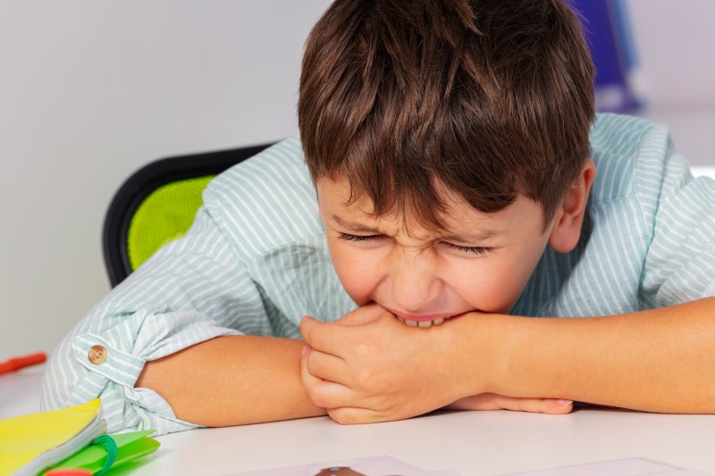 child biting their hand 
